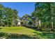 Spacious brick home with well-maintained lawn, mature trees, and architectural details at 4586 Chanel Ct, Concord, NC 28025