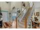 Welcoming foyer boasts hardwood floors, a grand staircase, and an ornate chandelier in the entryway at 4586 Chanel Ct, Concord, NC 28025