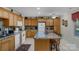 Kitchen featuring abundant counter space, a kitchen island with chairs and ample cabinetry at 4586 Chanel Ct, Concord, NC 28025