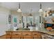 Kitchen island with stainless steel sink, granite counters, and view to breakfast nook at 4586 Chanel Ct, Concord, NC 28025