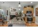 Open-concept kitchen with island, stainless steel appliances, and view to the living room fireplace at 4586 Chanel Ct, Concord, NC 28025
