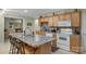 This kitchen boasts a center island with barstool seating, and modern white appliances at 4586 Chanel Ct, Concord, NC 28025
