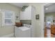 Laundry room featuring a washer, dryer, storage cabinets, and a window at 4586 Chanel Ct, Concord, NC 28025