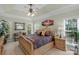 Main bedroom suite with tray ceilings, a ceiling fan, and neutral decor at 4586 Chanel Ct, Concord, NC 28025
