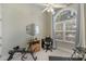 Bright office space features a large window with curtains, a ceiling fan, and modern workout equipment at 4586 Chanel Ct, Concord, NC 28025