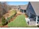 Spacious, newly seeded backyard with fresh mulch, brick fire place, and black metal fence at 5025 Antebellum Dr, Iron Station, NC 28080