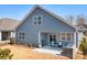 Exterior view of home with a covered porch, brick fire place, and blue siding at 5025 Antebellum Dr, Iron Station, NC 28080