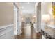 Inviting hallway with dark hardwood floors leading to a bright living area at 5025 Antebellum Dr, Iron Station, NC 28080