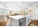 Open kitchen with a large island, stainless steel dishwasher, and seamless transition to the living and dining areas at 5025 Antebellum Dr, Iron Station, NC 28080