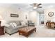 Comfortable living room with soft couch, gray chair, and view into bedroom at 5025 Antebellum Dr, Iron Station, NC 28080