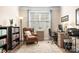Comfortable home office with a bookshelf, chair, desk, and natural light at 5025 Antebellum Dr, Iron Station, NC 28080