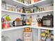 Organized walk-in pantry with shelves stocked with various food items and kitchen essentials at 5025 Antebellum Dr, Iron Station, NC 28080