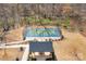 Aerial view of pickleball court, showing players, fencing, and seating area within a wooded community setting at 5025 Antebellum Dr, Iron Station, NC 28080