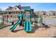 Community playground featuring colorful slides and climbing structures, set against a backdrop of the clubhouse at 5025 Antebellum Dr, Iron Station, NC 28080