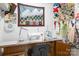 Bright sewing room with quilting machine, custom thread storage, and mountain themed wall quilt at 5025 Antebellum Dr, Iron Station, NC 28080