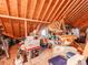 Unfinished attic space with exposed rafters and packed storage at 514 Baucom Deese Rd, Monroe, NC 28110