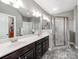 Stylish bathroom with a double vanity, tiled floors, and a glass-enclosed shower at 514 Baucom Deese Rd, Monroe, NC 28110