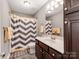 Bathroom with brown cabinets, marble countertop, and shower-tub combo at 514 Baucom Deese Rd, Monroe, NC 28110