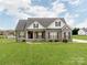 Charming single-Gathering home with a well-manicured lawn and a classic brick facade under a cloudy sky at 514 Baucom Deese Rd, Monroe, NC 28110