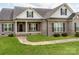 Close up view of the front exterior with a brick facade, black shutters, and a well-kept lawn at 514 Baucom Deese Rd, Monroe, NC 28110