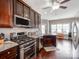 Modern kitchen boasts stainless steel appliances, dark cabinets, granite counters, and stylish hardwood flooring at 514 Baucom Deese Rd, Monroe, NC 28110