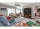 Open living room featuring hardwood floors, a ceiling fan, and neutral-toned furnishings at 514 Baucom Deese Rd, Monroe, NC 28110