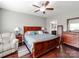 Cozy main bedroom features hardwood floors, ceiling fan, and ensuite bathroom access at 514 Baucom Deese Rd, Monroe, NC 28110