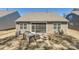 Home's backyard features a screened porch, patio with brick outdoor grill, and well-manicured lawn at 525 Cellini Pl, Mount Holly, NC 28120