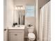 Well-lit bathroom with a single vanity, modern fixtures, and a shower-tub combo with a curtain at 525 Cellini Pl, Mount Holly, NC 28120