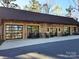 Modern exterior with garage doors, rocking chairs and ample parking space at 525 Cellini Pl, Mount Holly, NC 28120