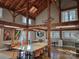 Bright and airy interior with high ceilings, exposed beams, large windows, and multi-purpose tables and chairs at 525 Cellini Pl, Mount Holly, NC 28120