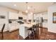Bright kitchen featuring an island with bar seating, white cabinets, and stainless steel appliances at 525 Cellini Pl, Mount Holly, NC 28120