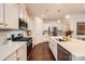 Stylish kitchen with white cabinets, stainless steel appliances, and hardwood floors at 525 Cellini Pl, Mount Holly, NC 28120