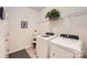 Functional laundry room with modern white appliances, shelving, and decor at 525 Cellini Pl, Mount Holly, NC 28120
