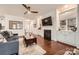 Inviting living room with hardwood floors, built-in cabinets, fireplace, and plenty of natural light at 525 Cellini Pl, Mount Holly, NC 28120