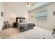 Neutral main bedroom with fan, generous natural light, and dark wood accents at 525 Cellini Pl, Mount Holly, NC 28120