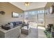 Cozy screened porch with comfortable seating, ceiling fan, and serene backyard views at 525 Cellini Pl, Mount Holly, NC 28120