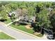 Aerial view of the property, showcasing its lush surroundings and well-manicured lawn at 5344 Saddlewood Ln, Mint Hill, NC 28227
