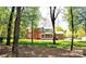 Backyard of home features lush landscaping and mature trees at 5344 Saddlewood Ln, Mint Hill, NC 28227