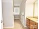 Bathroom featuring granite countertops and cabinets, and a window for natural light at 5344 Saddlewood Ln, Mint Hill, NC 28227