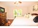 Comfortable bedroom featuring a warm ambiance, neutral walls, and a window providing plenty of natural light at 5344 Saddlewood Ln, Mint Hill, NC 28227