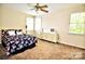 Bedroom with neutral walls and carpet, featuring a double bed and window for natural light at 5344 Saddlewood Ln, Mint Hill, NC 28227