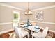 Dining room featuring a modern marble-look table, seating for six, and decorative wainscoting at 5344 Saddlewood Ln, Mint Hill, NC 28227