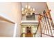 Grand entryway with a staircase and chandelier, leading into a home with a fireplace and natural light at 5344 Saddlewood Ln, Mint Hill, NC 28227