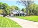 Attractive home with a well-manicured lawn and a long driveway leading to an attached garage at 5344 Saddlewood Ln, Mint Hill, NC 28227