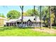Charming brick home featuring a welcoming front porch and beautifully landscaped front yard at 5344 Saddlewood Ln, Mint Hill, NC 28227
