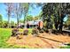Exterior of home features green lawn and mature trees at 5344 Saddlewood Ln, Mint Hill, NC 28227
