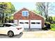 Spacious two-car garage with a brick facade and an overhead window on a sunny day at 5344 Saddlewood Ln, Mint Hill, NC 28227