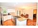 Bright kitchen with island cooktop, granite countertops, and dining nook with sliding door access at 5344 Saddlewood Ln, Mint Hill, NC 28227