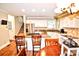 Spacious kitchen features granite countertops, stainless steel appliances, and wood flooring at 5344 Saddlewood Ln, Mint Hill, NC 28227